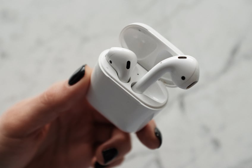 Person Holding White Apple Airpods